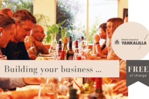 People seated around a table enjoying food and wine.