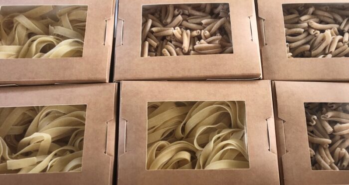 Fresh handmade pasta in cardboard display boxes. 
