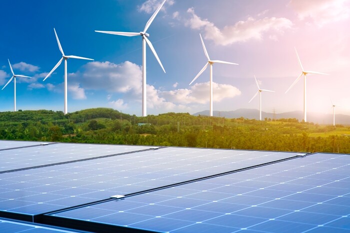 Wind turbines and solar panels in a field.