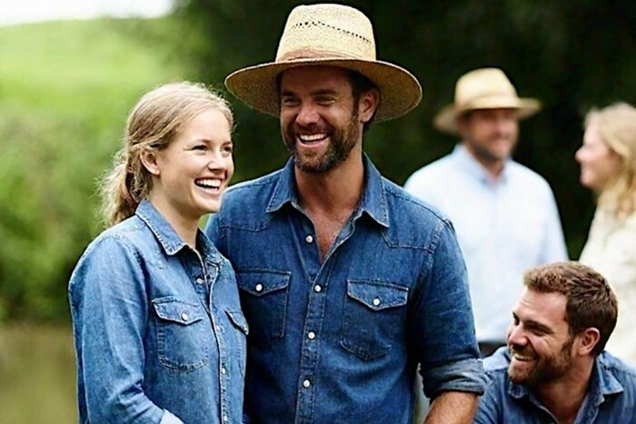 Farming couple relaxing with other people in the farming community