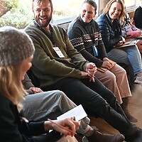 Participants of the Inspired Leadership 2024 class sitting together laughing.
