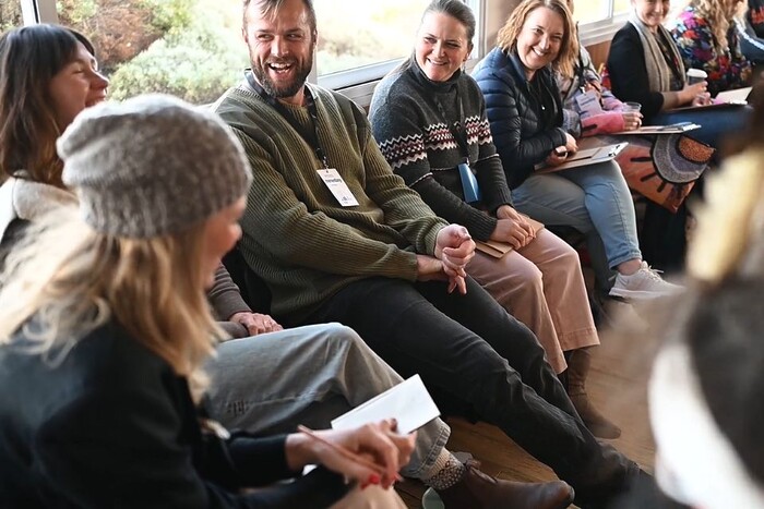 Participants of the Inspired Leadership 2024 class sitting together laughing.